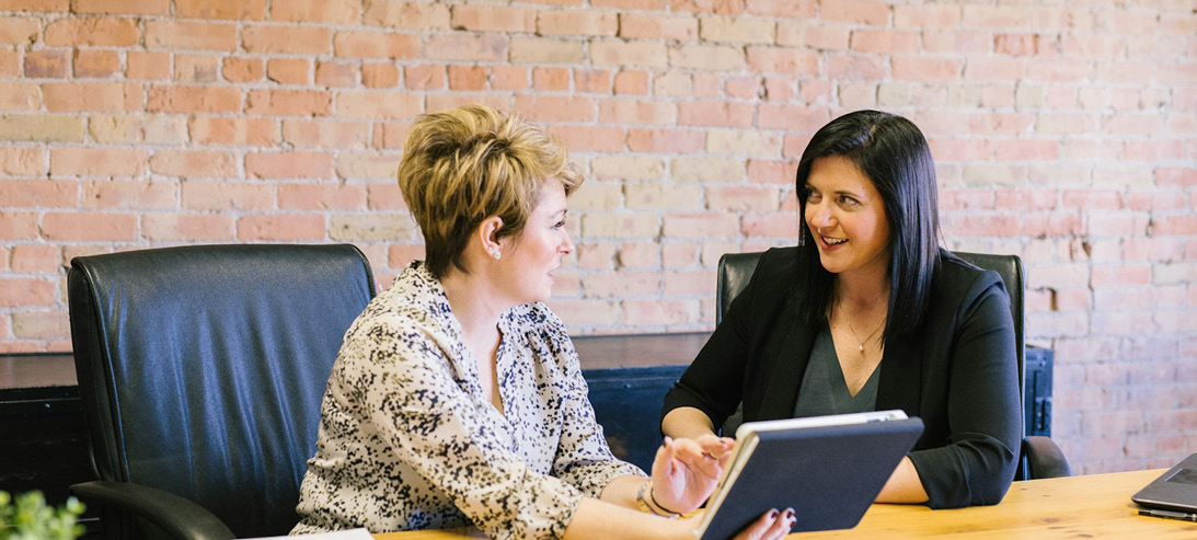 Two women chatting in an office